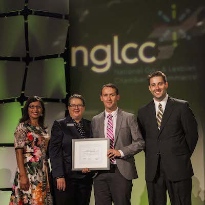Chamber Vice President Harry Young (third from left) and Board Member Cory Messinger (fourth from left) accept the 2014 National Chamber Excellence Community Impact Award from Sam McClure (second from left), NGLCC Vice President of Affiliate Relations and External Affairs. (Photo by NGLCC)